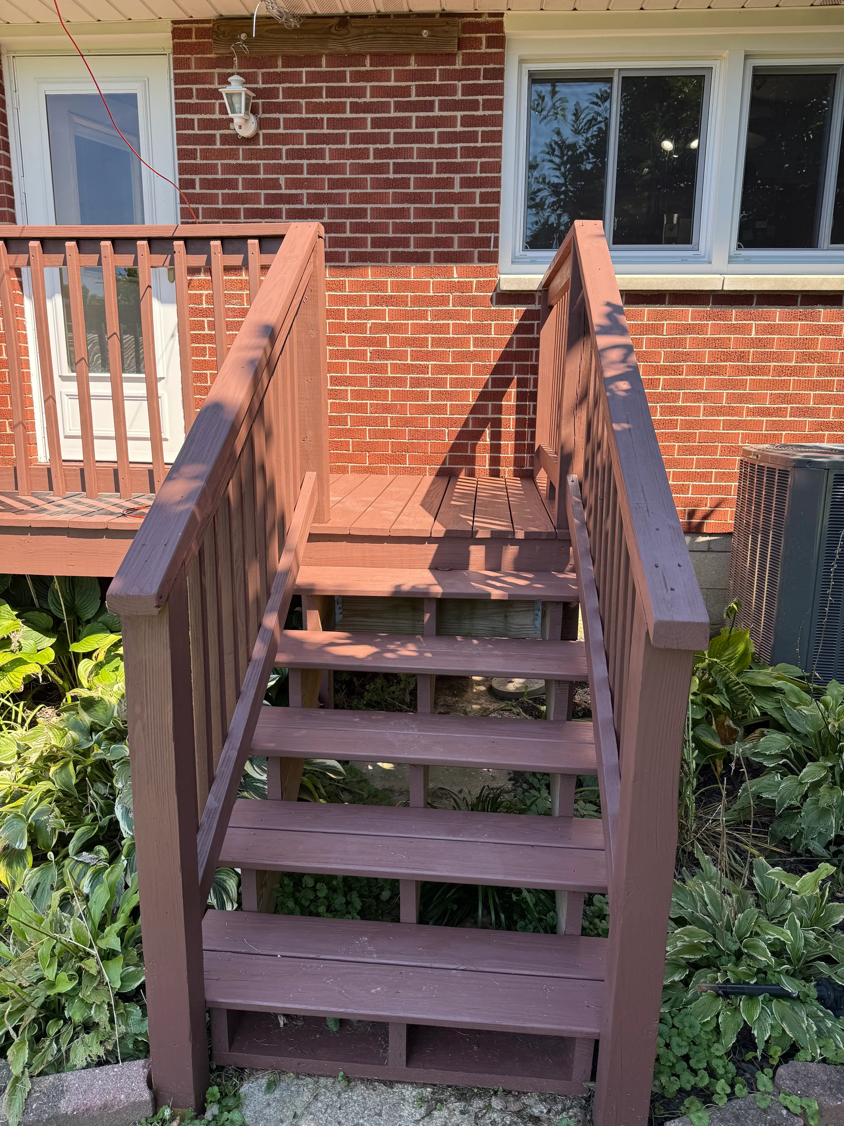 Finished deck steps and handrails viewed from the garden