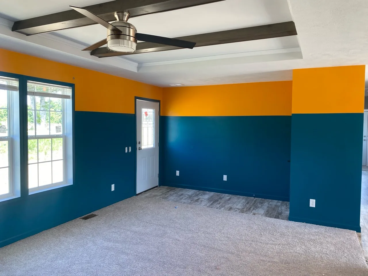 Second view of the finished teal and golden-orange room with white tray ceiling